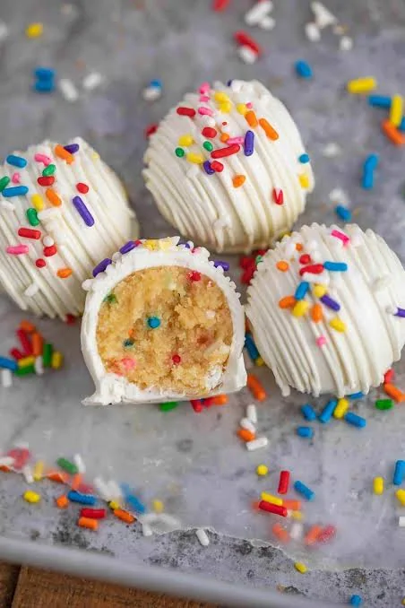 Funfetti Fuel Pops coated in white candy coating and rainbow sprinkles